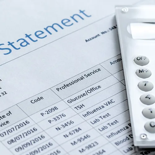 Billing statement with listed services and charges, partially covered by a white calculator on the right side